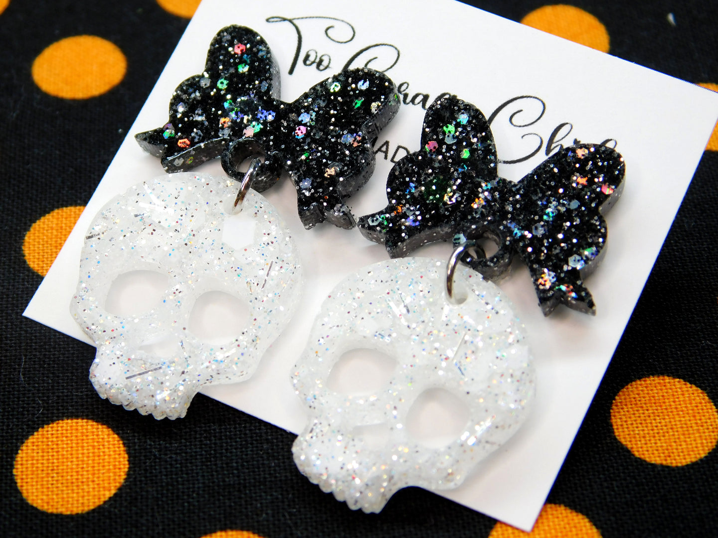1 in. White Skull Dangles w/ Black Bow Tops